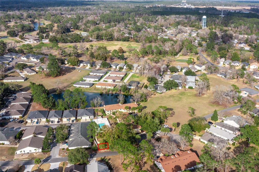 An aerial view shows a residential neighborhood with a vacant lot outlined in red — 6400 NW 106TH PLACE UNIT 21, ALACHUA, FL