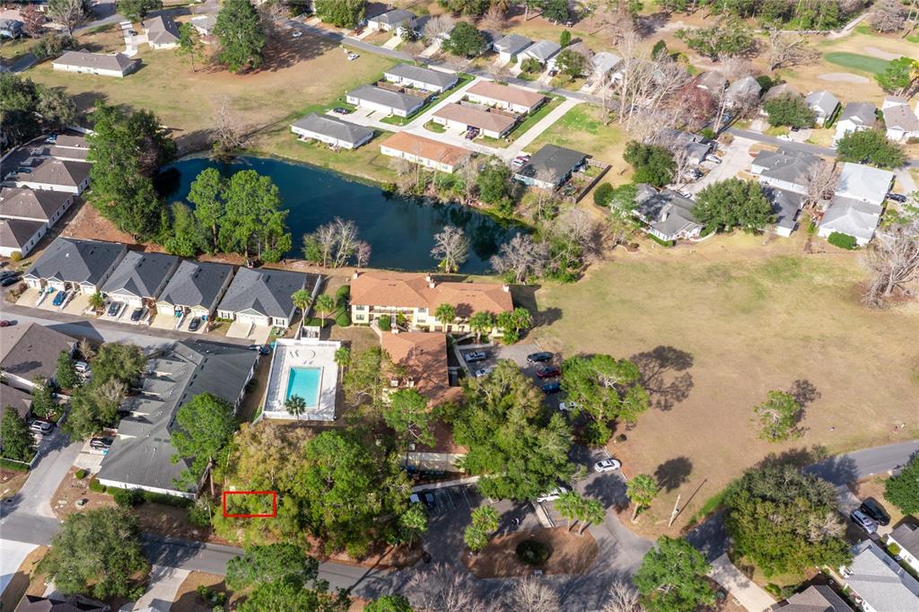An aerial view shows a residential complex with a pool, pond, and surrounding neighborhood — 6400 NW 106TH PLACE UNIT 21, ALACHUA, FL