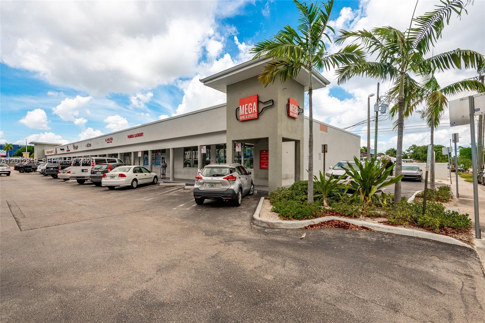 A strip mall with a Mega Wine & Spirits store and a parking lot — 3941 NW 7 ST, Miami FL 33126, MIAMI, FL