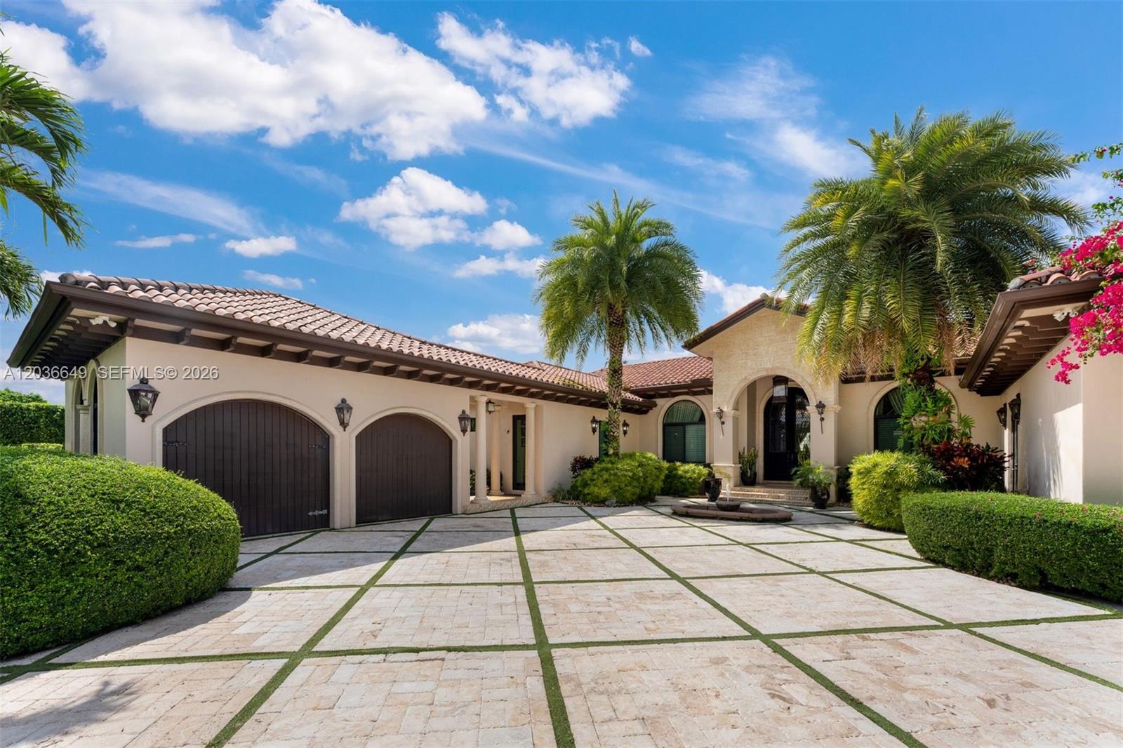 A single-story house with a tiled roof, arched garage doors, and a paved driveway — 10270 SW 62nd St, Miami FL 33173, MIAMI, FL