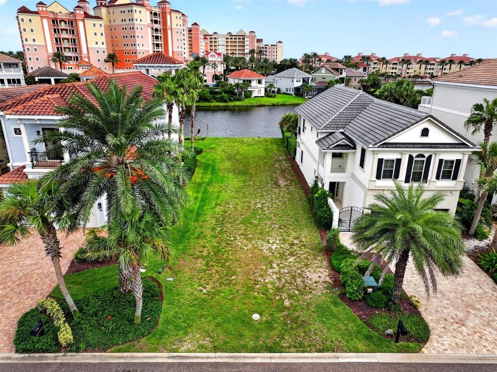 An aerial view shows a vacant grassy lot situated between two houses near a canal — 41 NORTHSHORE AVENUE, PALM COAST, FL