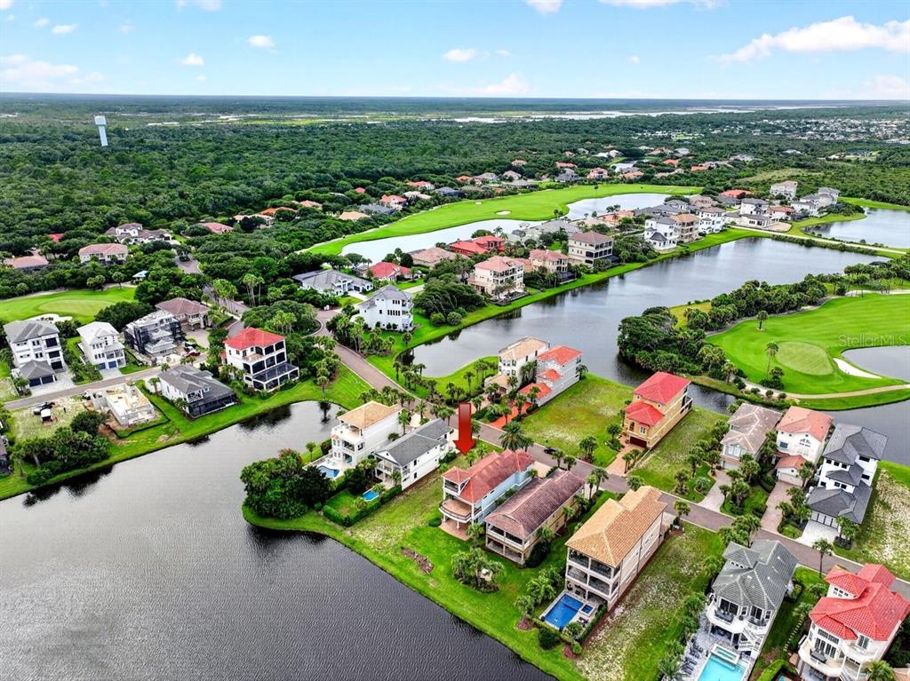 An aerial view shows waterfront houses with pools along a golf course and lake — 41 NORTHSHORE AVENUE, PALM COAST, FL