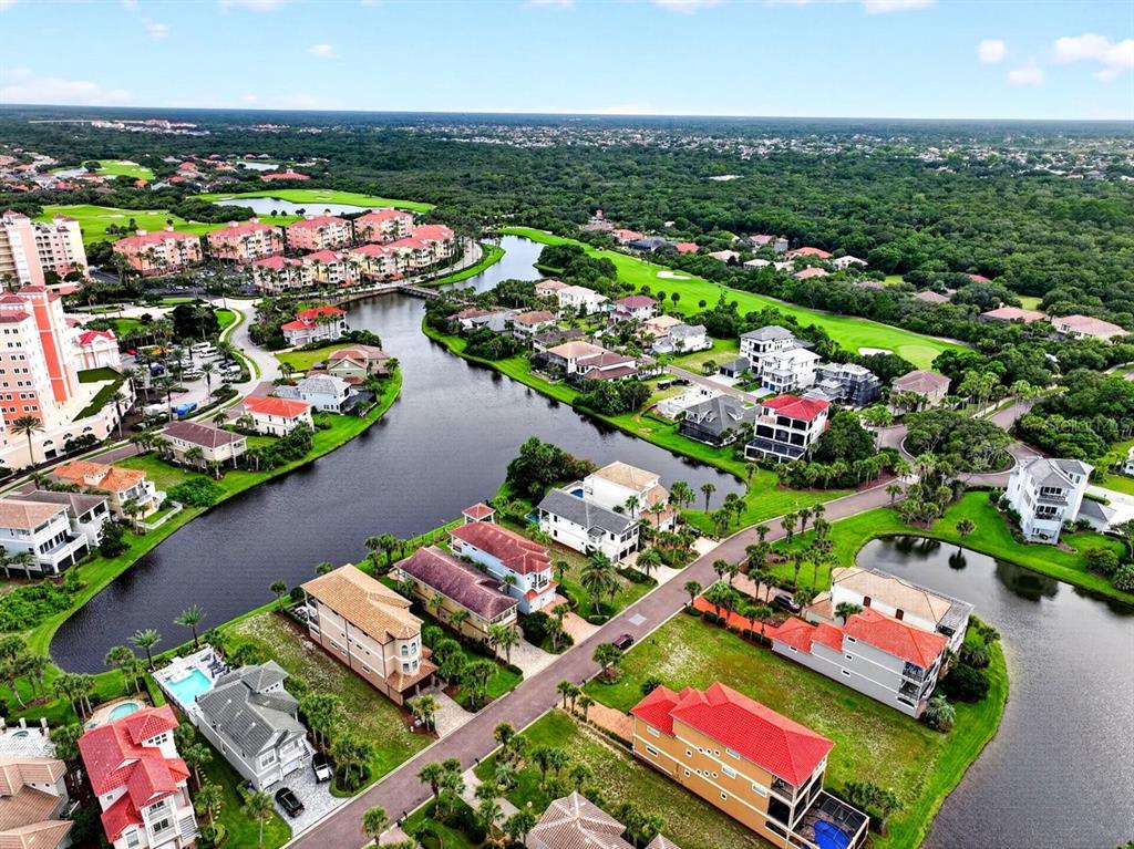 An aerial view shows a residential neighborhood with houses situated along a winding canal — 41 NORTHSHORE AVENUE, PALM COAST, FL