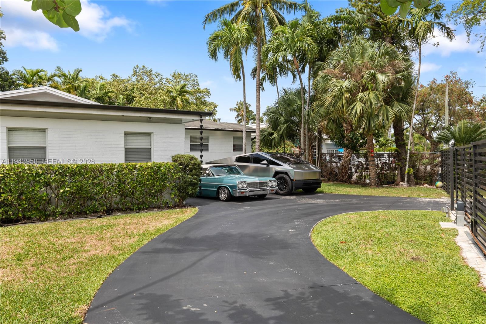 A teal classic car and a silver Cybertruck are parked in a residential driveway — 11810 W Biscayne Canal Rd, Miami FL 33161, MIAMI, FL