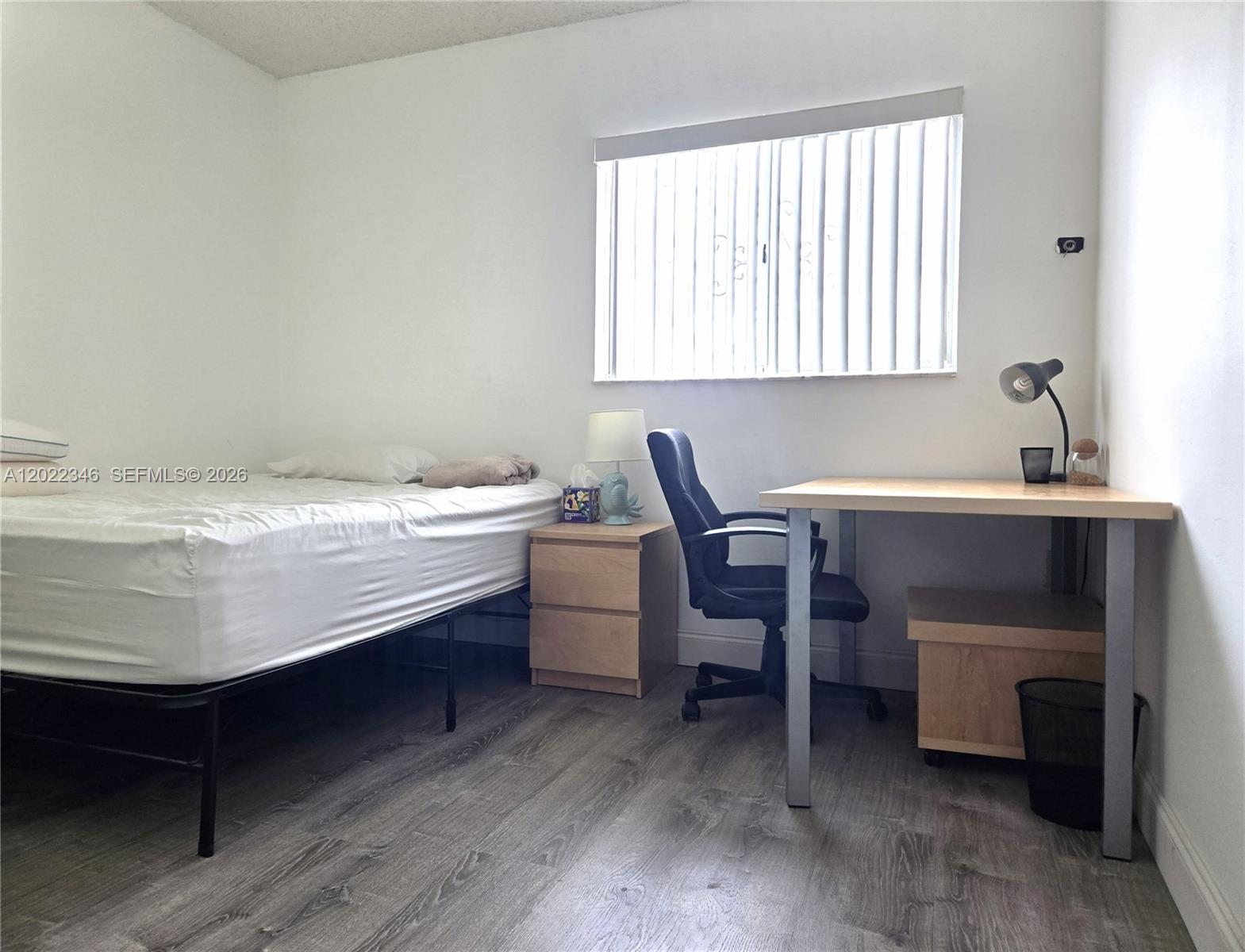 A bedroom features a single bed, a desk with a chair, and wood-look flooring — 900 SW 104th Ct # 108, Miami FL 33174, MIAMI, FL
