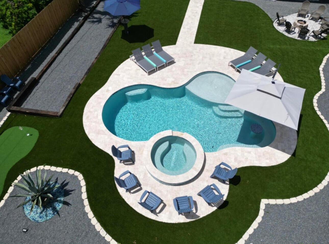 An aerial view of a backyard featuring a swimming pool, hot tub, and lounge chairs — 270 NW 36th Street, Boca Raton FL 33431, BOCA RATON, FL