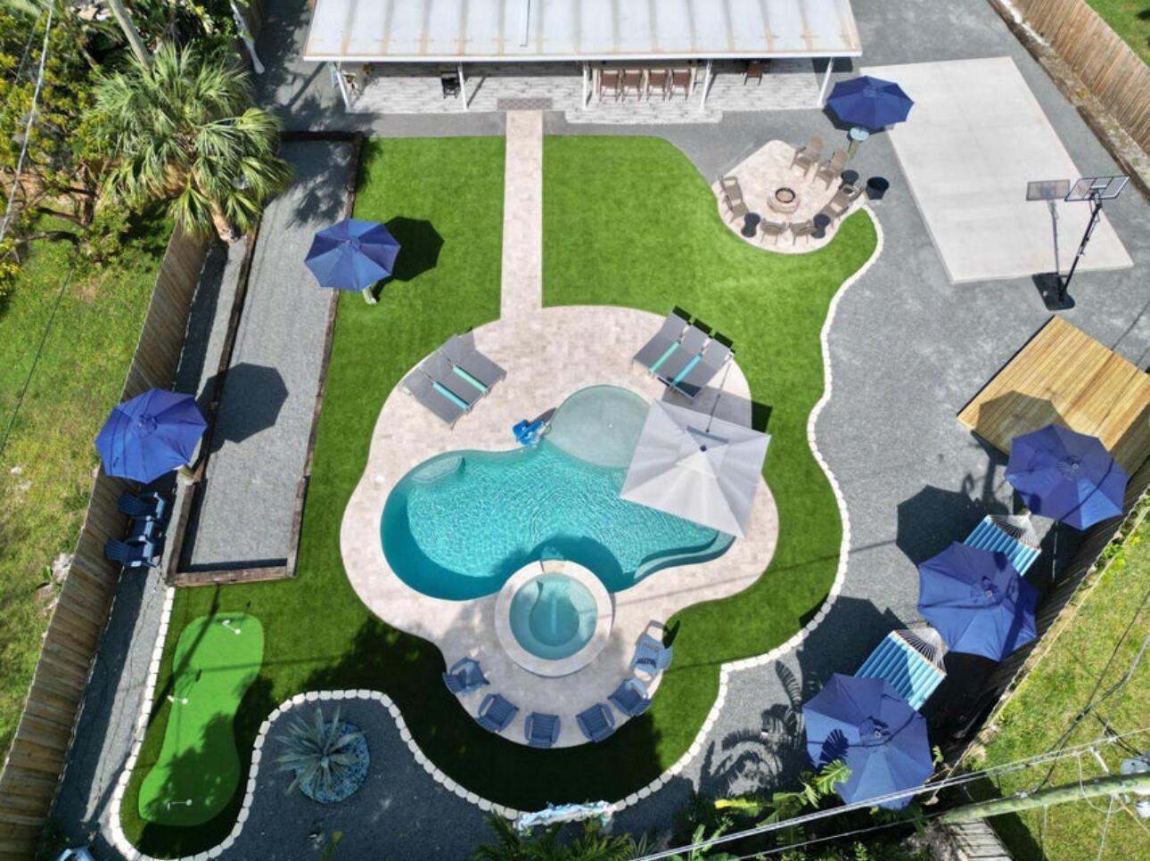 An aerial view of a backyard featuring a pool, hot tub, patio, and putting green — 270 NW 36th Street, Boca Raton FL 33431, BOCA RATON, FL