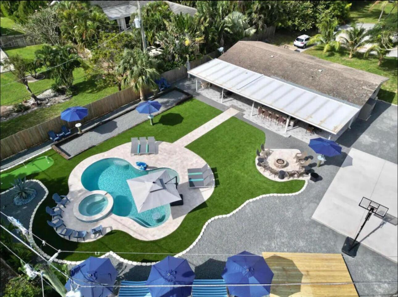 An aerial view of a backyard featuring a swimming pool, fire pit, and covered patio — 270 NW 36th Street, Boca Raton FL 33431, BOCA RATON, FL