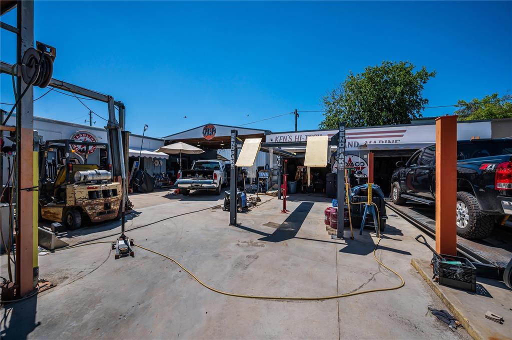 An outdoor automotive repair shop features a concrete lot, vehicle lifts, and parked trucks — 3580 66TH AVENUE N, PINELLAS PARK, FL