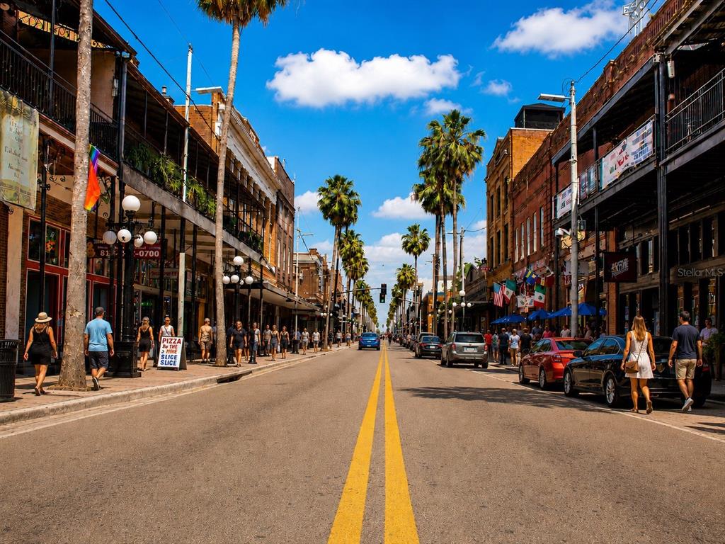 A street view of a historic downtown area lined with palm trees and brick buildings — 1212 E 25TH AVENUE, TAMPA, FL