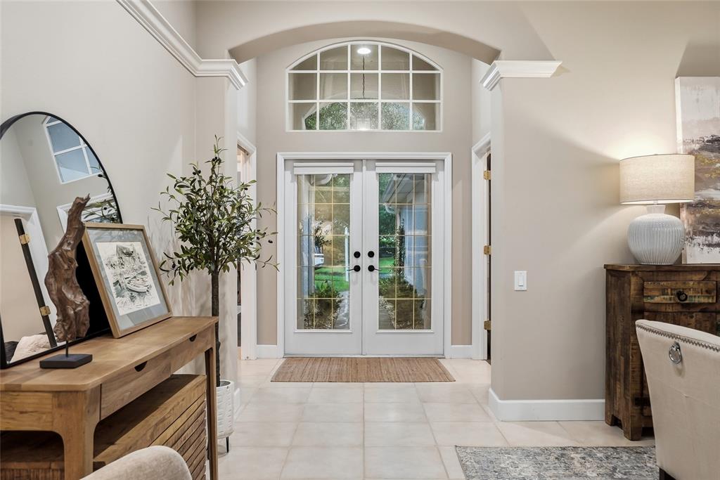 A single-story house exterior features a two-car garage, a brick walkway, and a front entrance — 10413 APPLECROSS LANE, TAMPA, FL