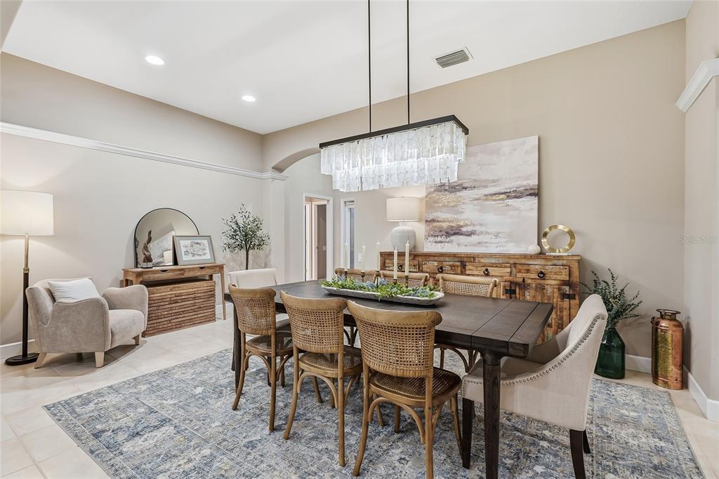 A brick walkway leads to a dark double front door under an arched entryway — 10413 APPLECROSS LANE, TAMPA, FL
