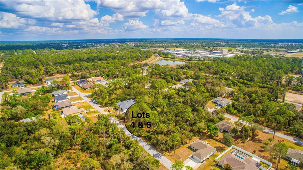 An aerial view shows a wooded residential area with two highlighted lots and nearby houses — DUNDEE AVENUE, NORTH PORT, FL