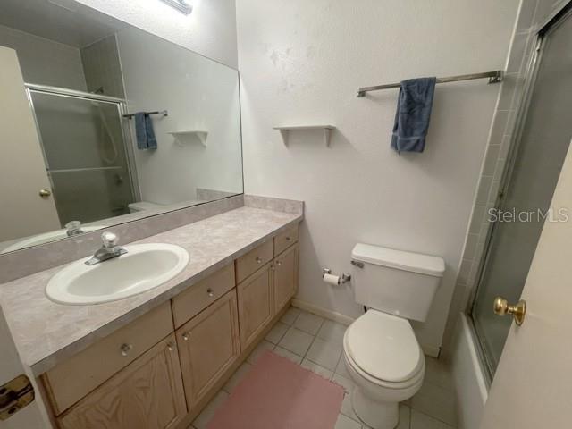 A bathroom features a light wood vanity, a large mirror, and a white toilet — 19717 GULF BOULEVARD UNIT V6, INDIAN ROCKS BEACH, FL