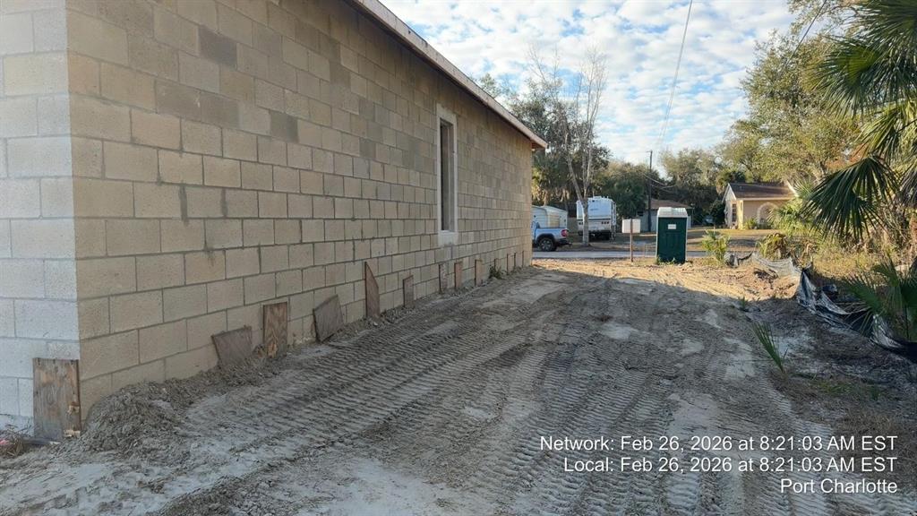 The exterior side of a concrete block house under construction with wooden shims at base — 17364 COX AVENUE, PORT CHARLOTTE, FL
