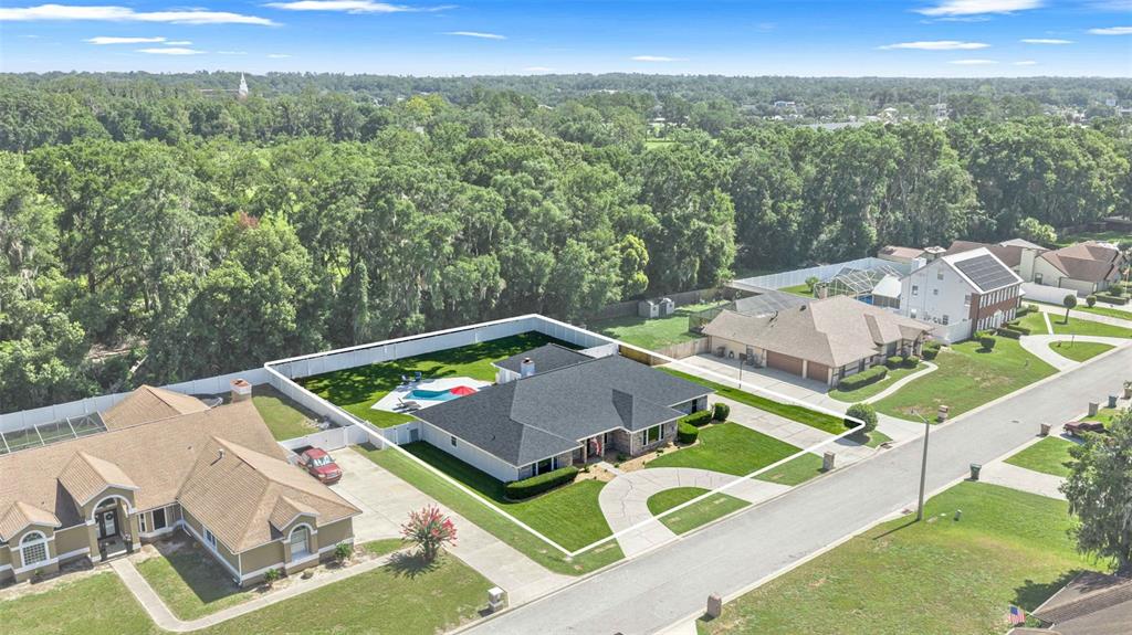 A single-story brick house with a circular driveway at dusk — 2611 SE 27 STREET, OCALA, FL