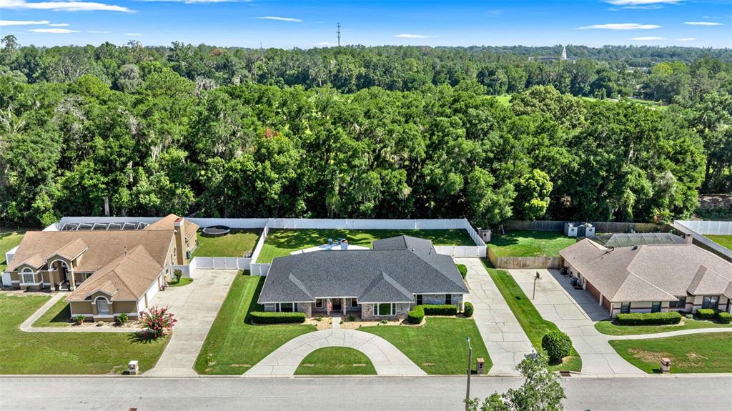 An aerial view shows a house with a shingled roof, pool, and patio area — 2611 SE 27 STREET, OCALA, FL