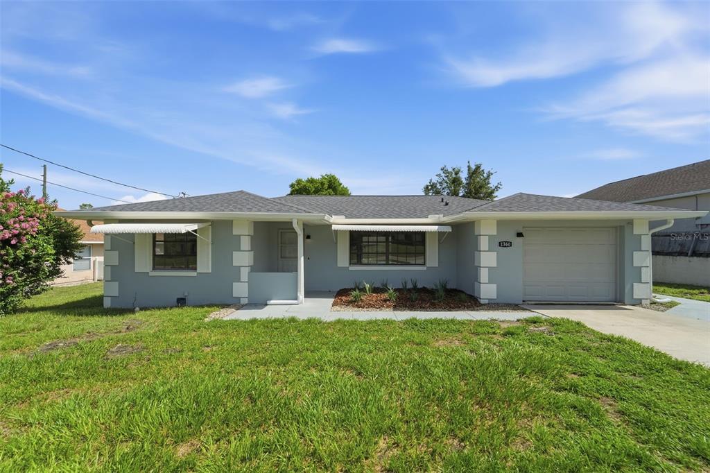A single-story house with a gray exterior, white trim, and an attached one-car garage — 1360 N OLD MILL DRIVE, DELTONA, FL
