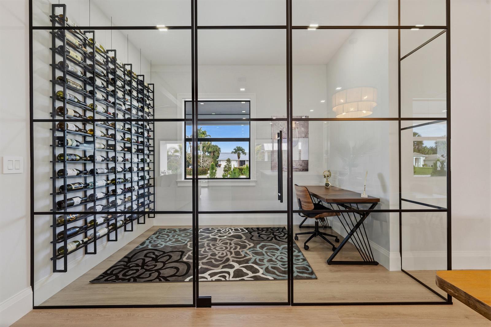 A home office with a glass wall, a wine rack, and a patterned area rug — 16149 73rd Terrace N, West Palm Beach FL 33418, WEST PALM BEACH, FL