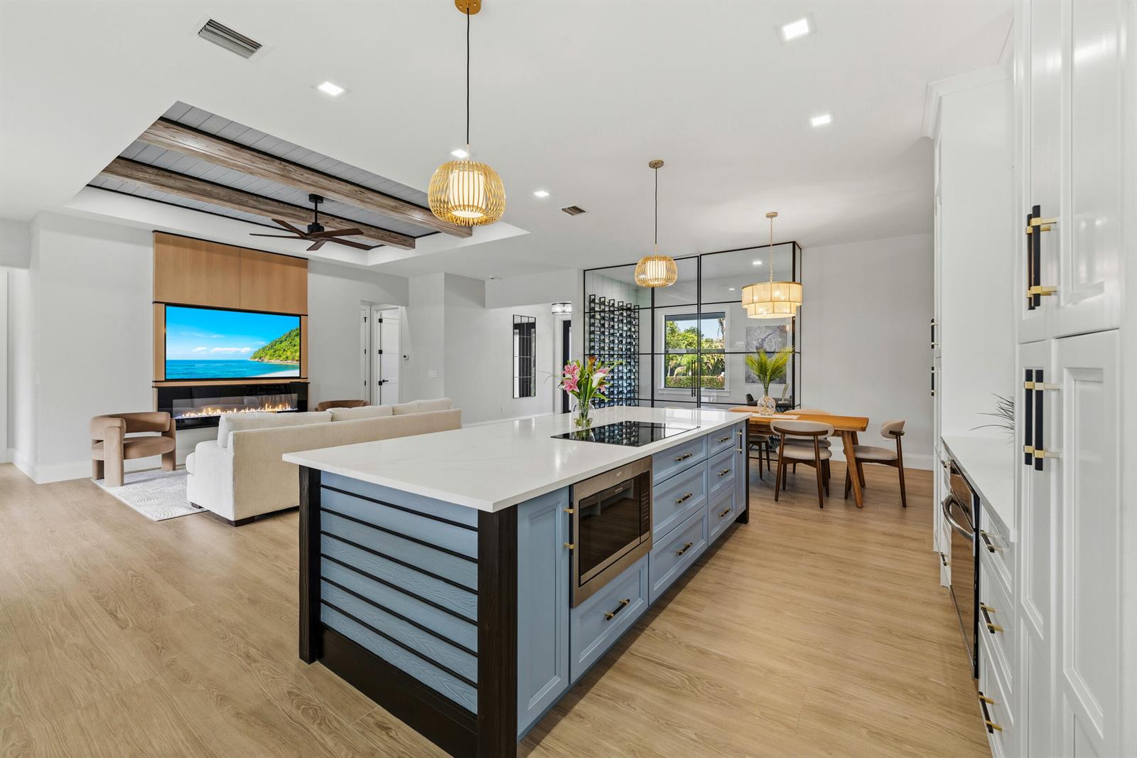 A kitchen with a blue island and white cabinets opens into a living room area — 16149 73rd Terrace N, West Palm Beach FL 33418, WEST PALM BEACH, FL