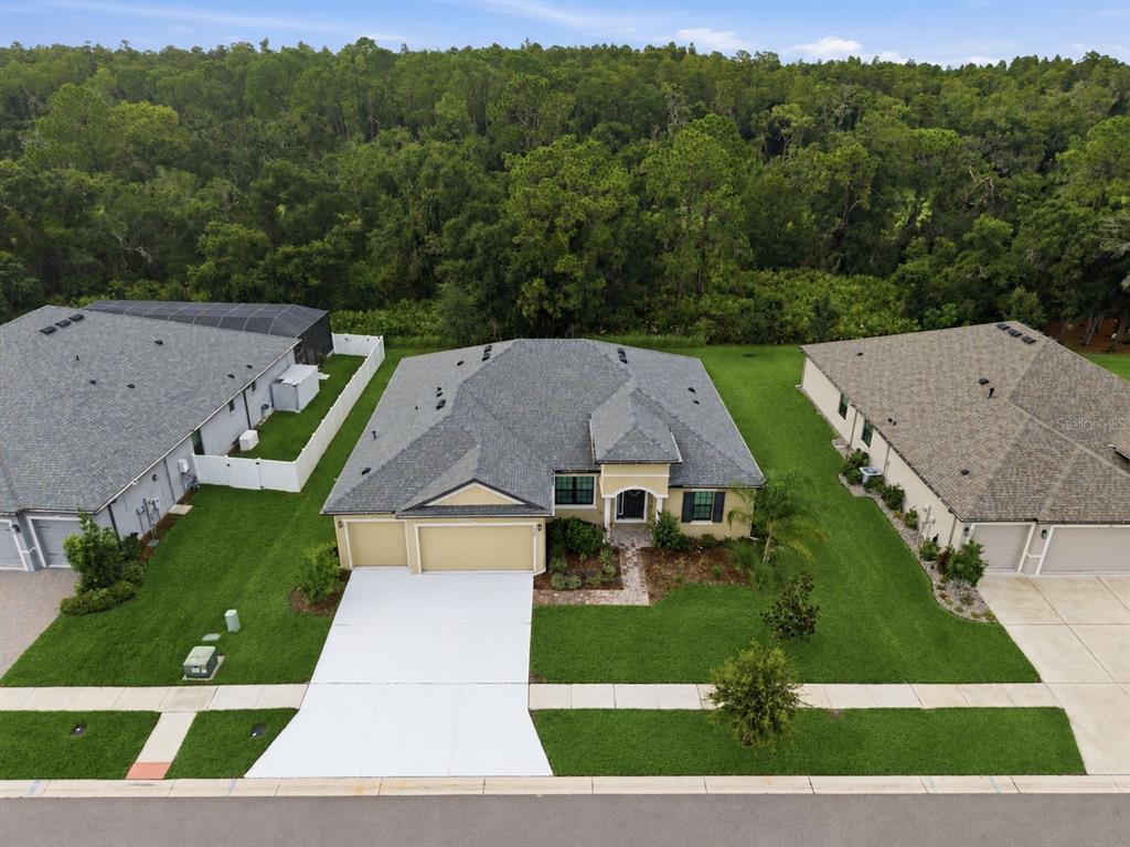 An aerial view shows a single-story house with a gray roof and a concrete driveway — 3908 GAVIOTA DRIVE, SUN CITY CENTER, FL