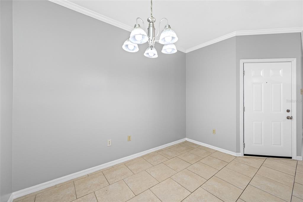 A dining area with light gray walls, tile flooring, and a multi-light chandelier — 5612 PINNACLE HEIGHTS CIRCLE UNIT 206, TAMPA, FL