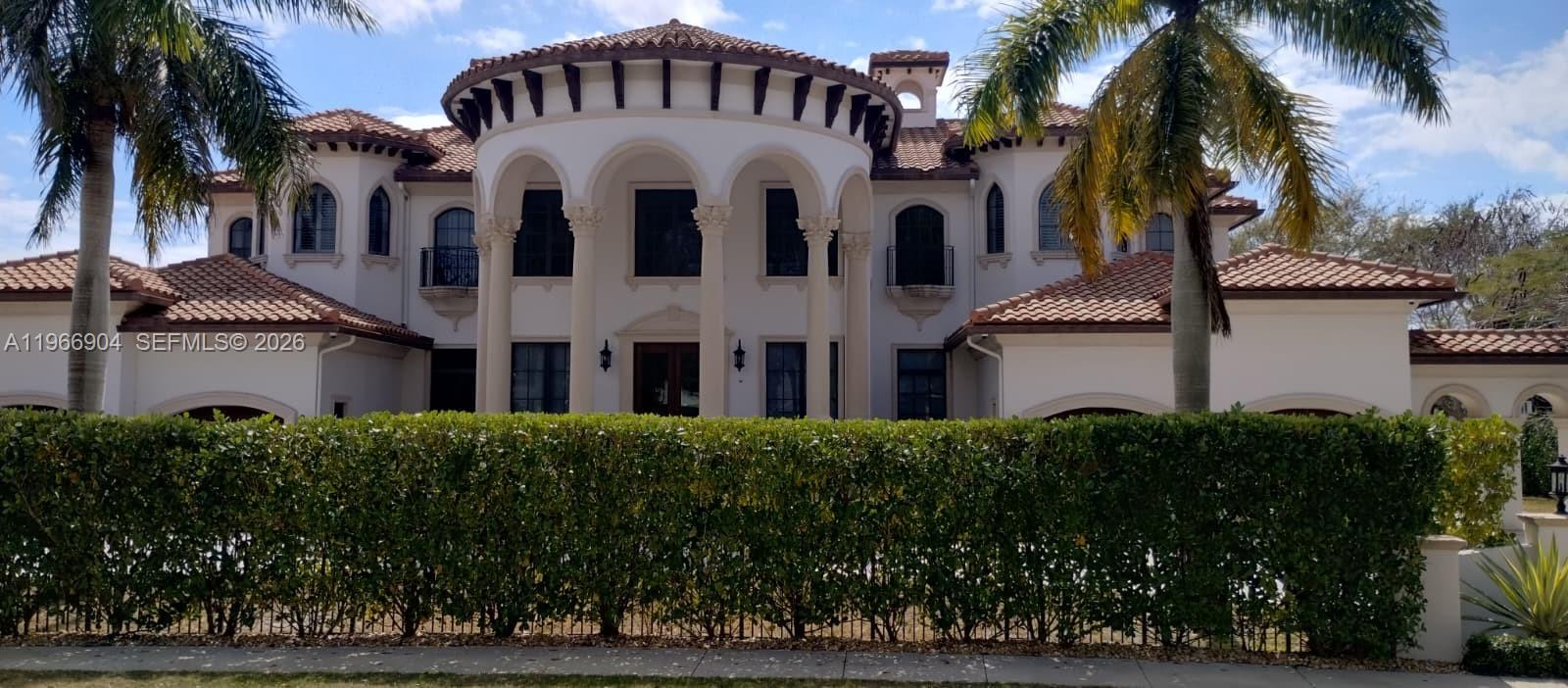 A two-story Mediterranean-style house with a central rotunda, arched columns, and a tiled roof — 7130 Lemon Grass Dr, Parkland FL 33076, PARKLAND, FL