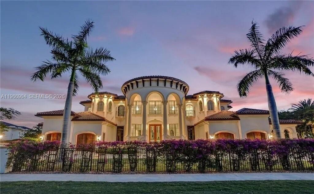 A large, two-story Mediterranean-style mansion with arched windows and two tall palm trees — 7130 Lemon Grass Dr, Parkland FL 33076, PARKLAND, FL