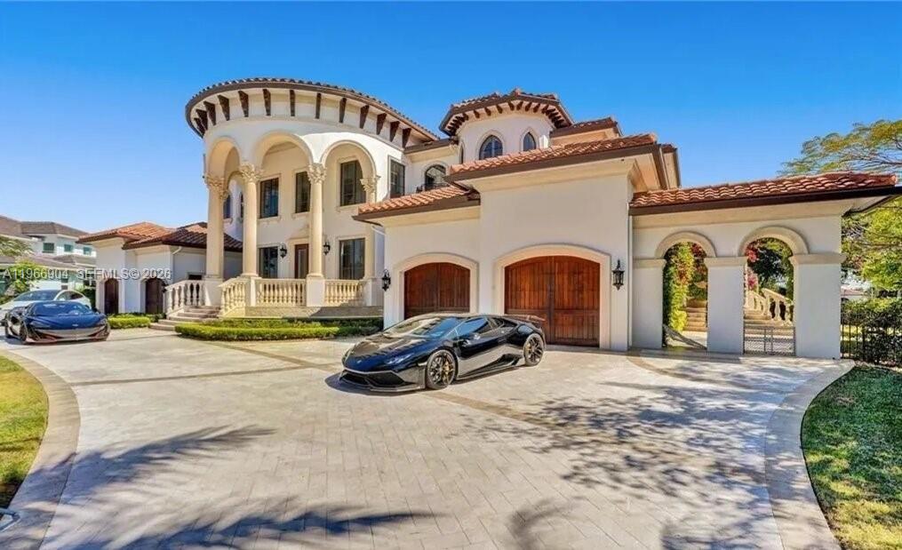 A large Mediterranean-style house with a circular tower and a black sports car parked outside — 7130 Lemon Grass Dr, Parkland FL 33076, PARKLAND, FL