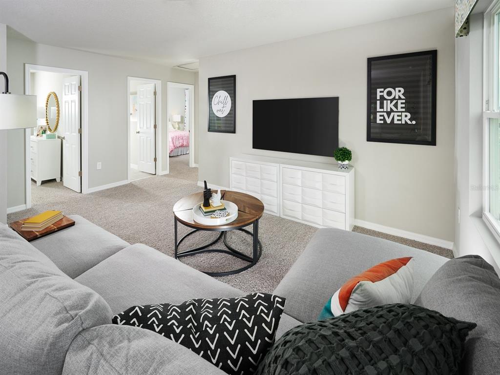 A living room features a grey sectional sofa, a round coffee table, and a wall-mounted television — 726 IMPALA ROAD, LAKE ALFRED, FL