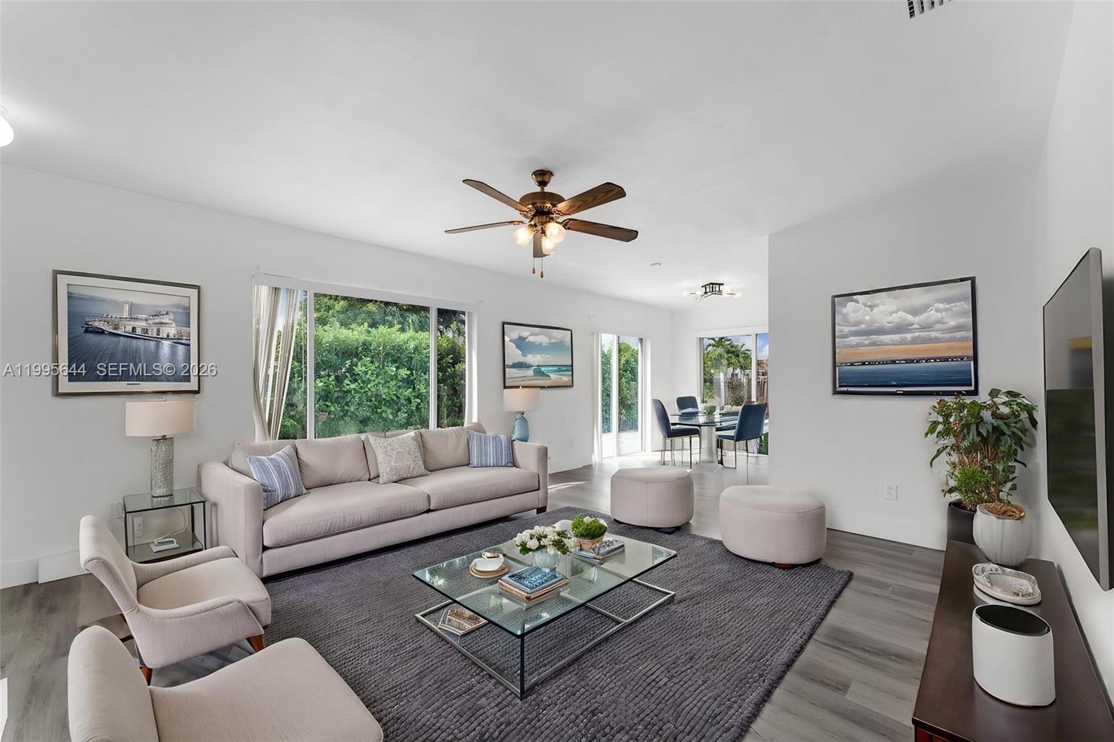 A living room features a gray area rug, a glass coffee table, and a sofa — 17570 SW 142nd Ct, Miami FL 33177, MIAMI, FL