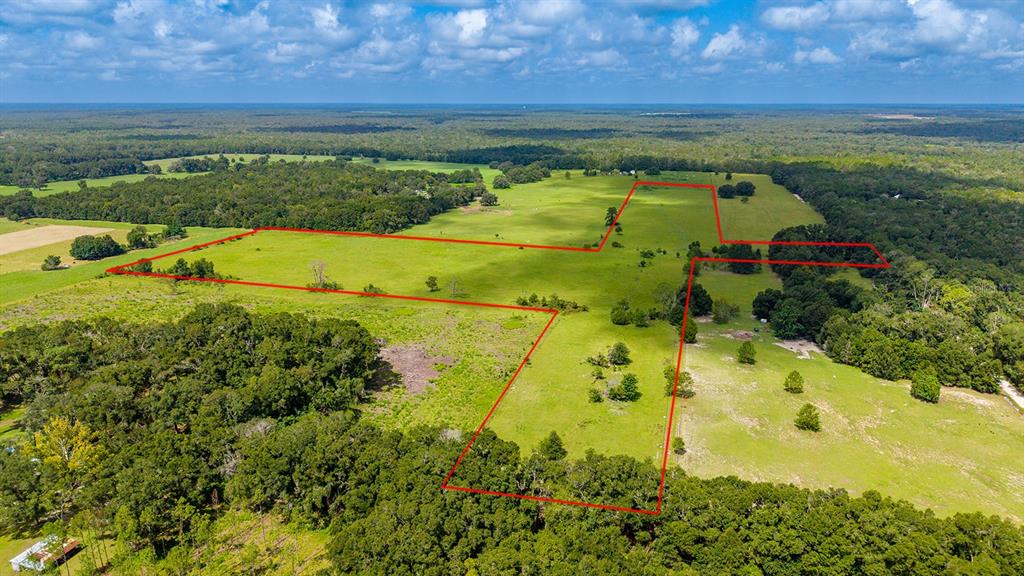 An aerial view shows a large, grassy plot of land outlined in red — 0000 NW 20TH STREET, BELL, FL