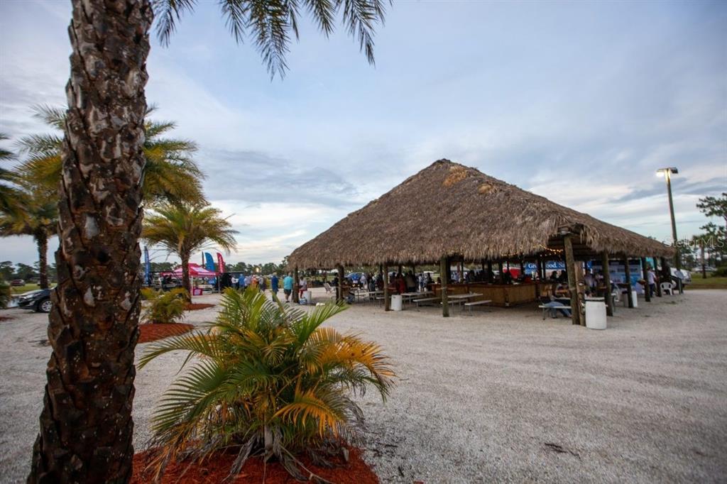 A large, open-air tiki hut with a thatched roof sits on a gravel lot — 104 HIGHWAY 630 E, LAKE WALES, FL