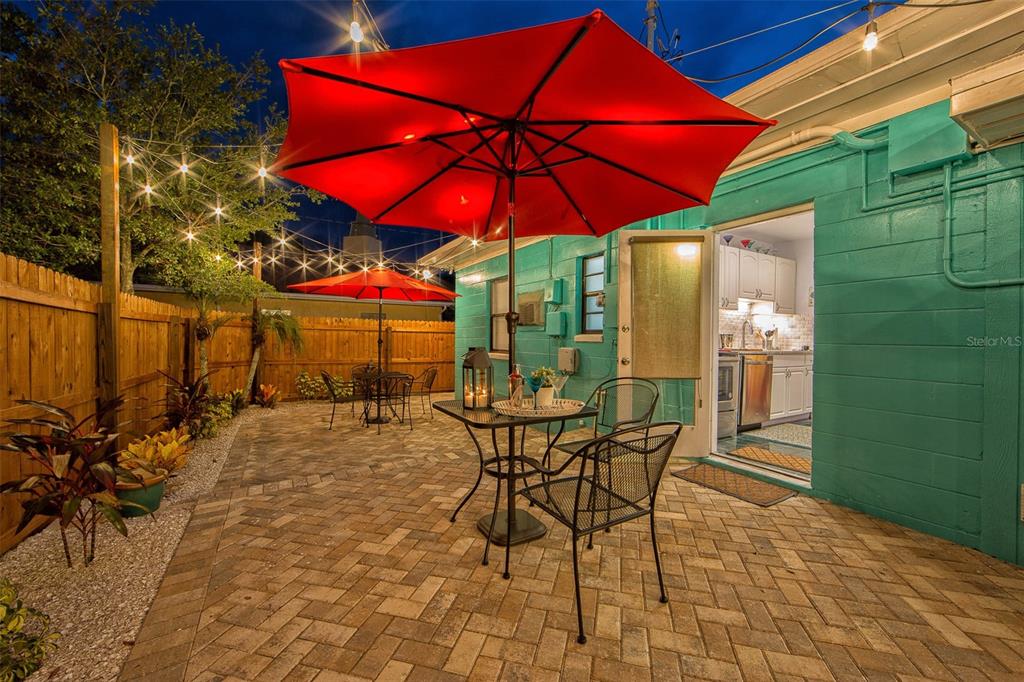 A living and dining area with tile floors, a red sofa, and a wooden dining set — 839 3RD STREET N, SAFETY HARBOR, FL