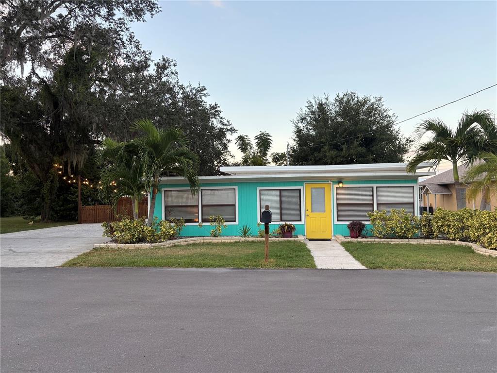 A kitchen with white cabinets, stainless steel appliances, granite countertops, and dark green tile floors — 839 3RD STREET N, SAFETY HARBOR, FL