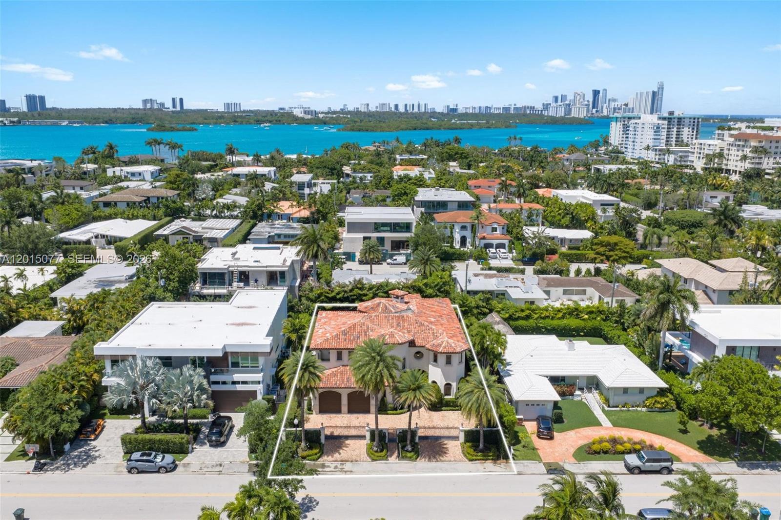 An aerial view shows a two-story Mediterranean-style house with a red tile roof — 1251 99th St, Bay Harbor Islands FL 33154, BAY HARBOR ISLANDS, FL