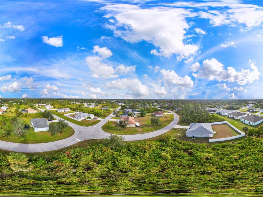 An aerial view shows several single-family homes situated along a paved road in Florida — 12142 APPLEBERG CIRCLE, PORT CHARLOTTE, FL