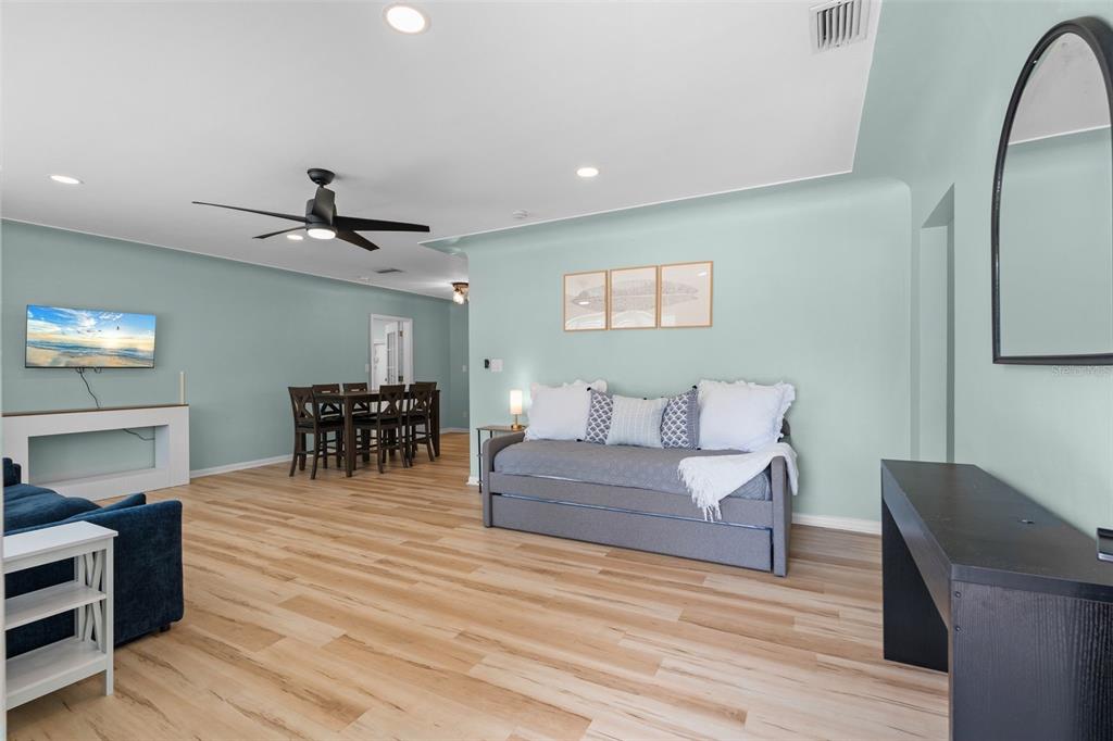 A backyard features a swimming pool, a patio area, and a blue house exterior — 7690 91ST STREET, SEMINOLE, FL
