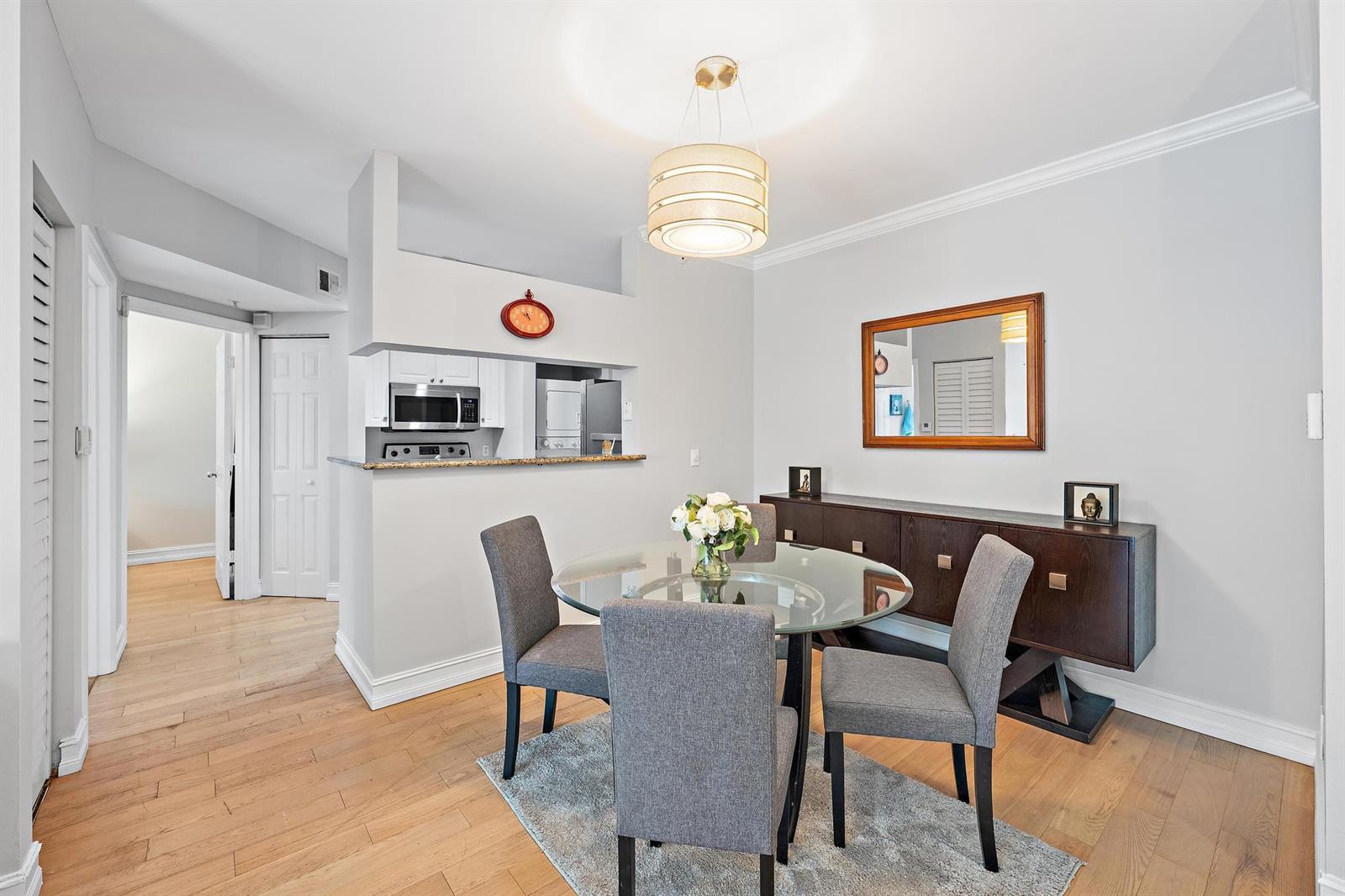 A dining area with a glass table, gray chairs, and a dark wood sideboard — 4117 Tuscany Way # 4117, Boynton Beach FL 33435, BOYNTON BEACH, FL