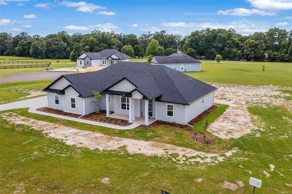 An aerial view of a newly constructed single-story house with gray siding and a dark roof — 0 SW MEADOW VIEW COURT, LAKE CITY, FL