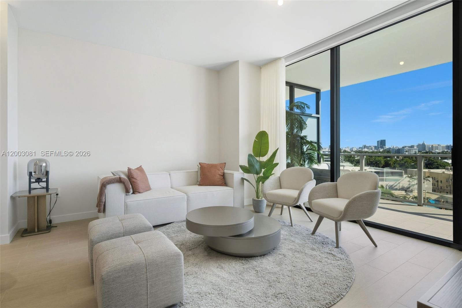 A modern living room features a white sofa, two armchairs, and a circular coffee table — 500 Alton Rd # 808, Miami Beach FL 33139, MIAMI BEACH, FL