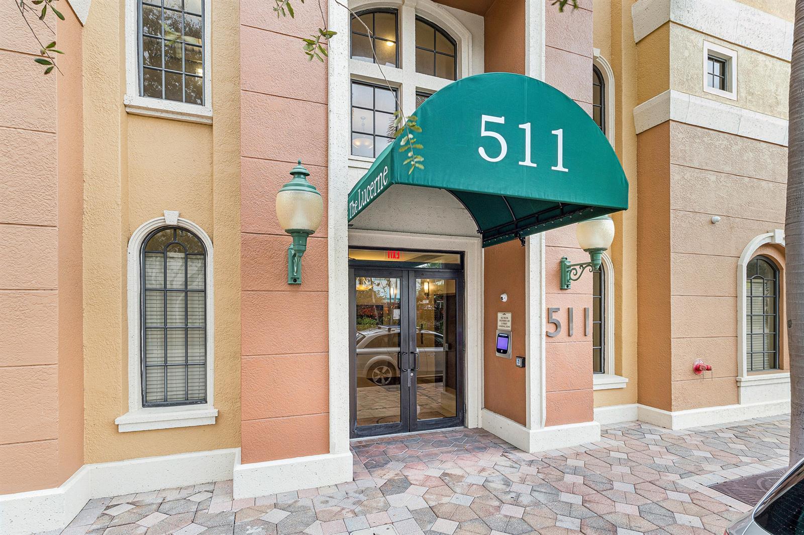 The exterior entrance of a building features a green awning with the number 511 — 511 Lucerne Avenue # 416, FL 33460, FL