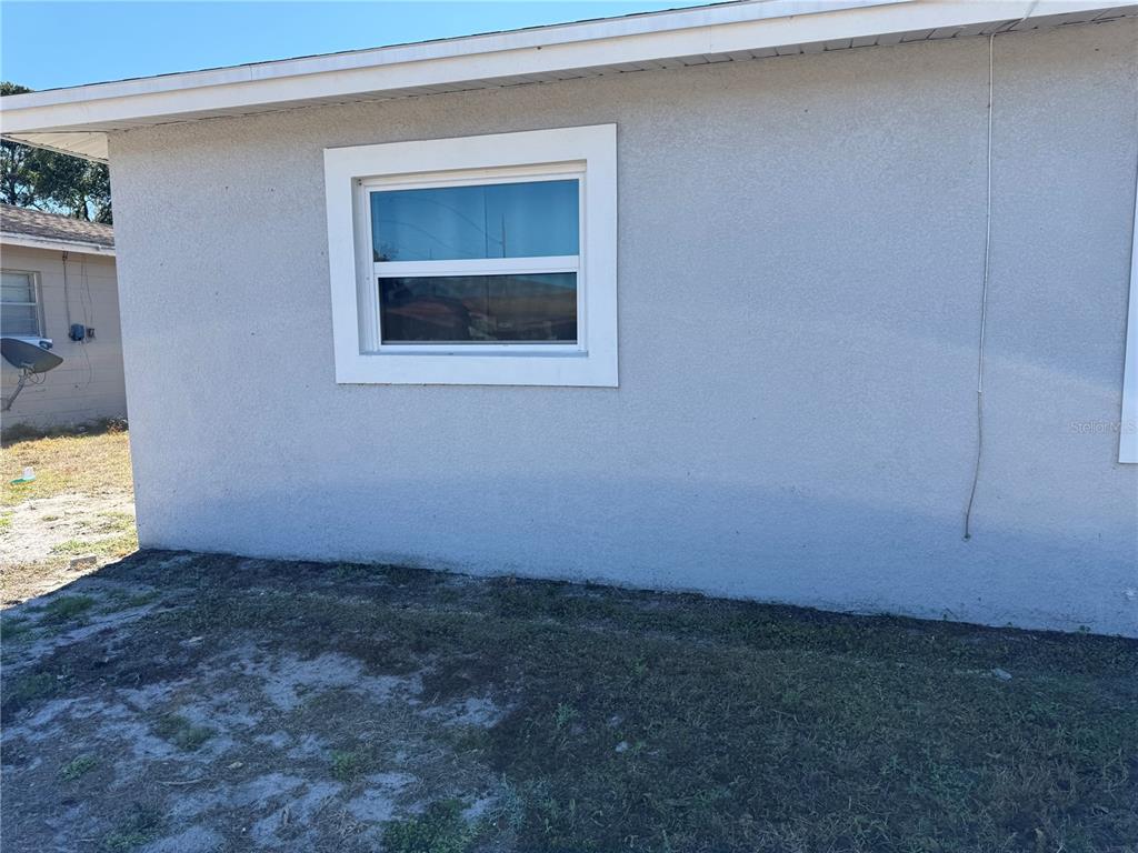 A side view of a house exterior featuring a single window with white trim — 204 6TH JPV STREET, WINTER HAVEN, FL