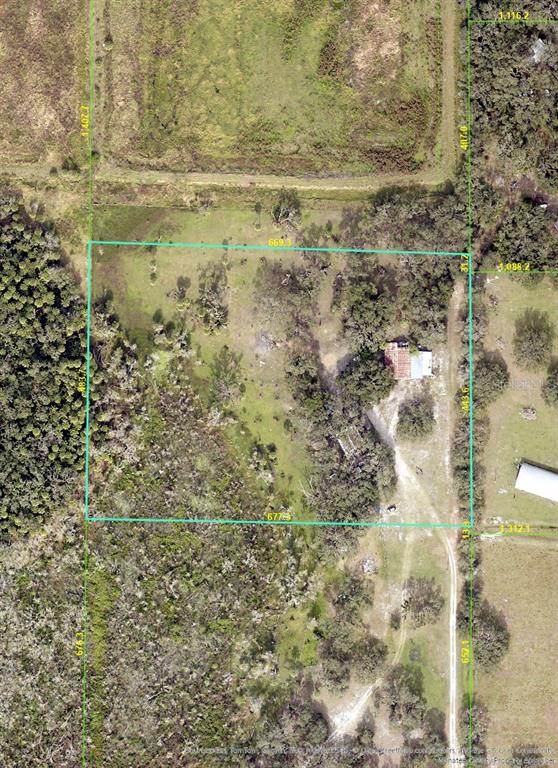 An aerial view of a rectangular property lot outlined in green with a small house — 12980 and 12990 RIVER ROAD, MYAKKA CITY, FL