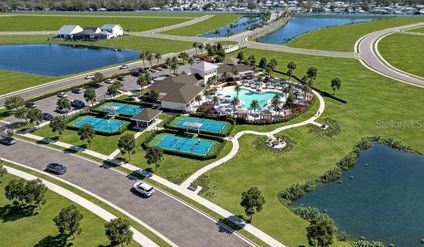A two-story white house with a metal roof, front porch, and a paved driveway — 721 ANEGADA LANE, SARASOTA, FL