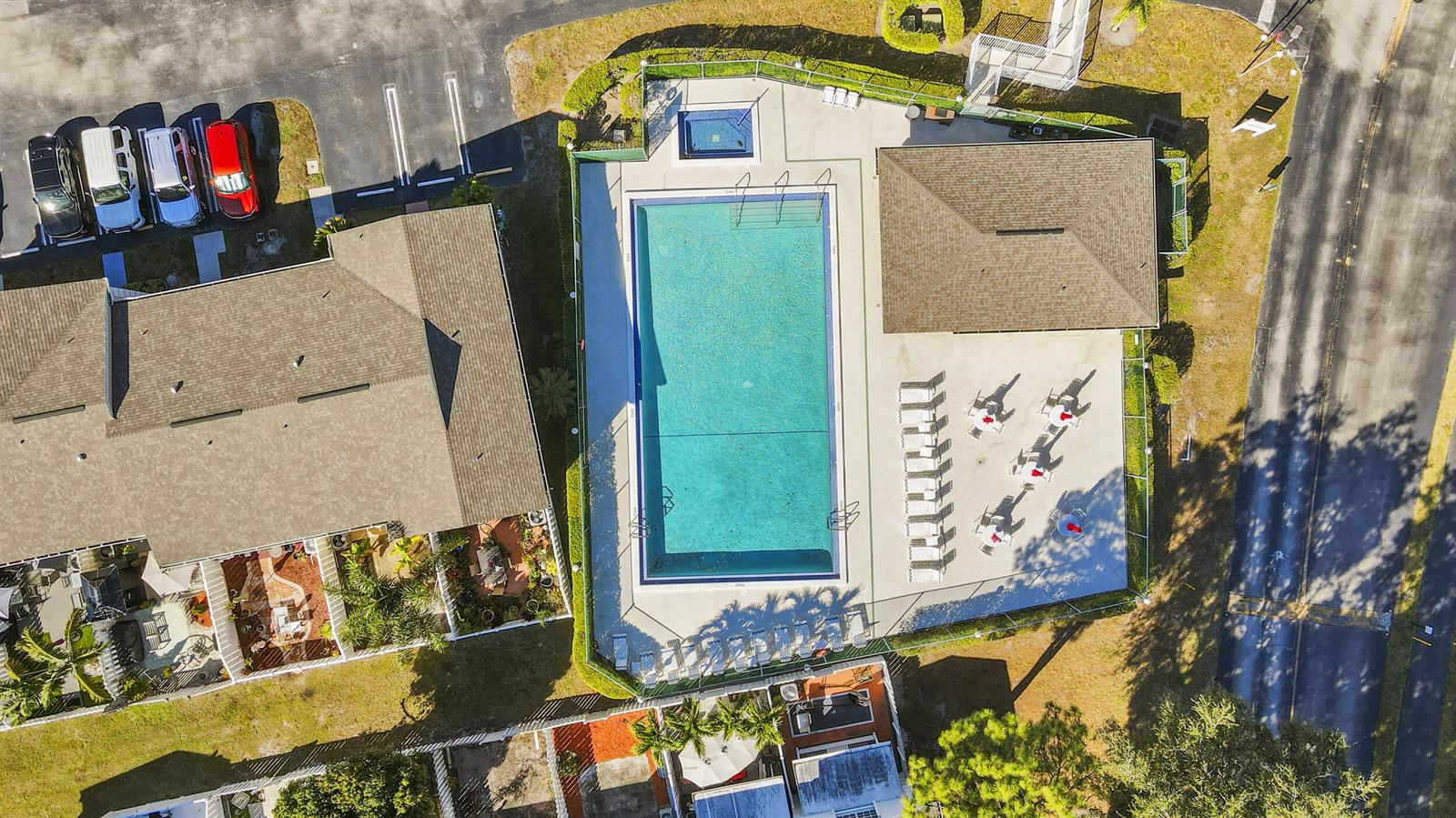 An aerial view shows a rectangular swimming pool, a hot tub, and a covered patio area — 218 Foxtail Drive # B, FL 33415, FL