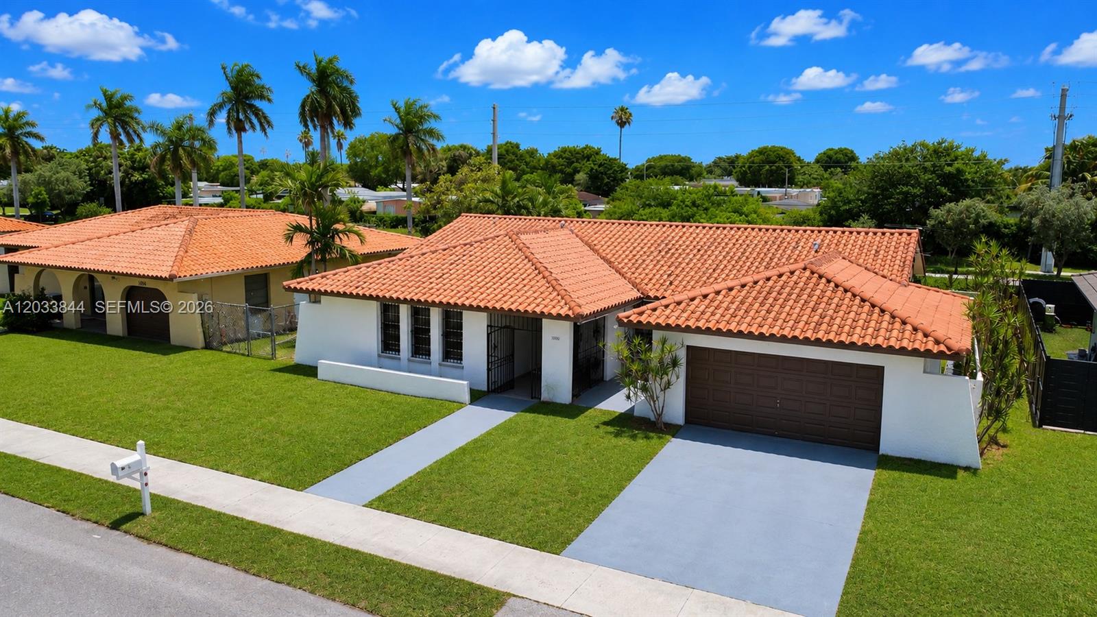 An aerial view of a single-story house with a terracotta tile roof and garage — 1330 SW 126th Pl, Miami FL 33184, MIAMI, FL