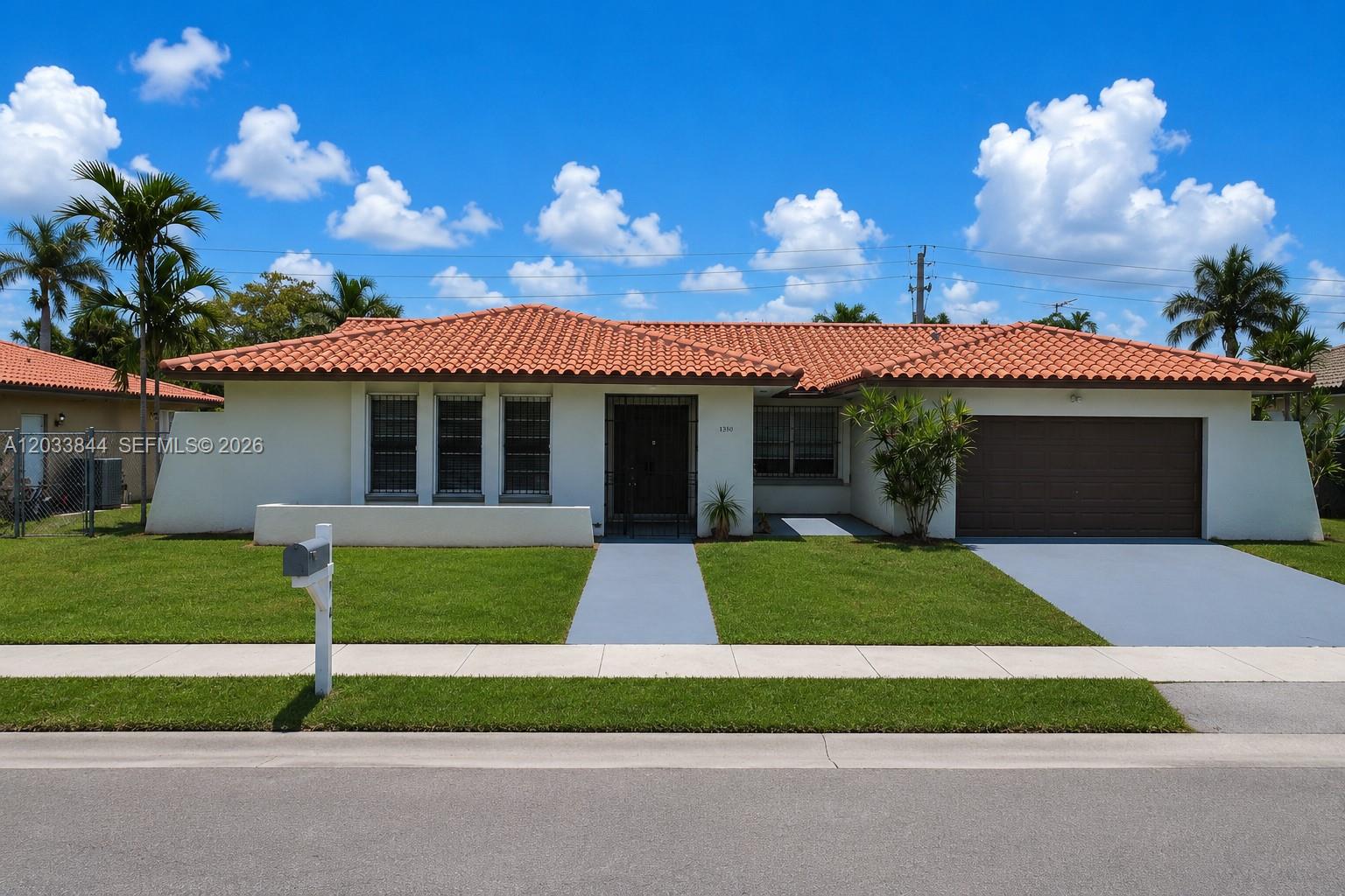 A single-story house with a red tile roof, white stucco walls, and a two-car garage — 1330 SW 126th Pl, Miami FL 33184, MIAMI, FL