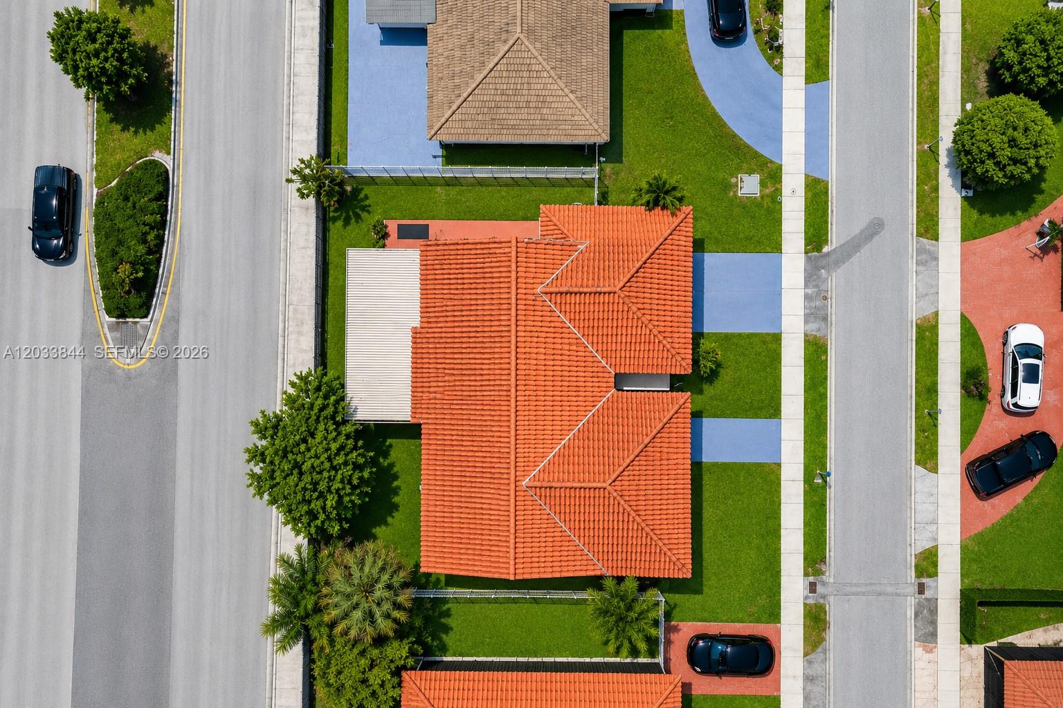 An aerial view shows a house with a red tile roof and a backyard patio — 1330 SW 126th Pl, Miami FL 33184, MIAMI, FL