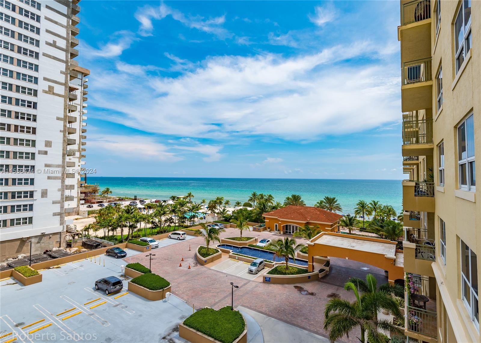 An elevated view shows a parking lot, a building entrance, and the ocean beyond — 2080 S Ocean Dr # 602, Hallandale Beach FL 33009, HALLANDALE BEACH, FL